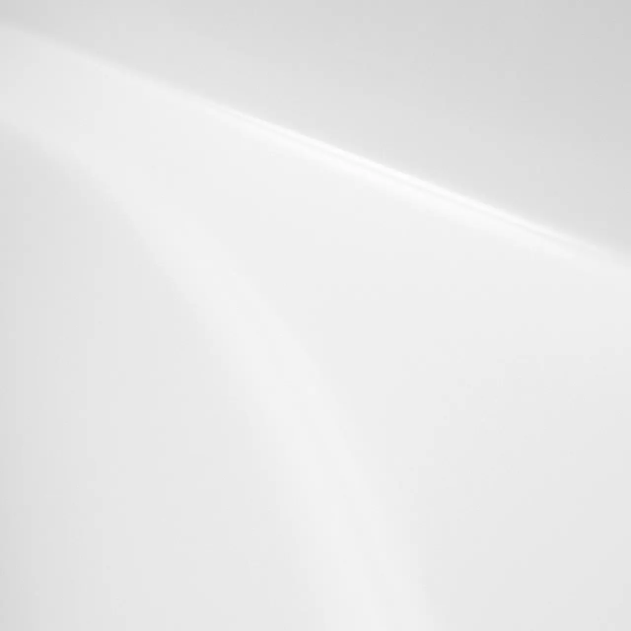 a black and white photo of a white wall